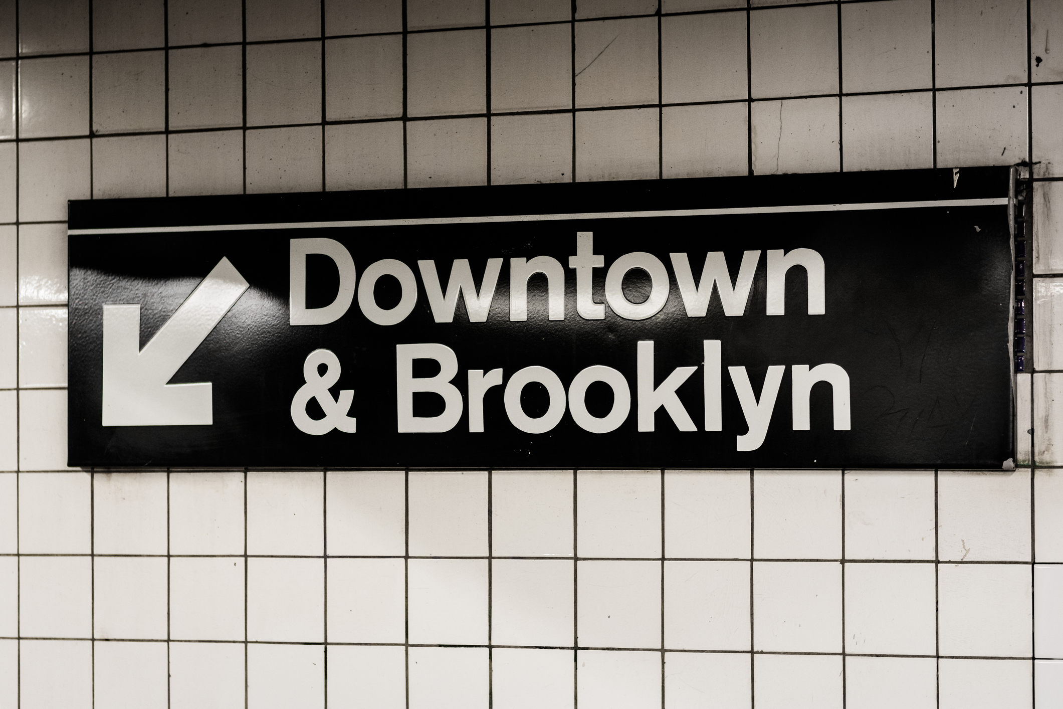 Downtown & Brooklyn sign in a subway station in Manhattan, New York City