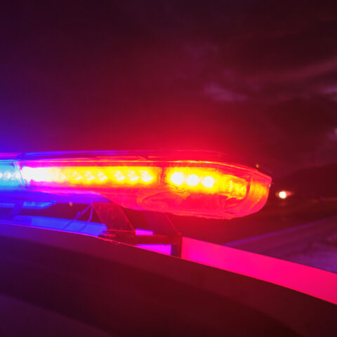 Police car with emergency lights at night.