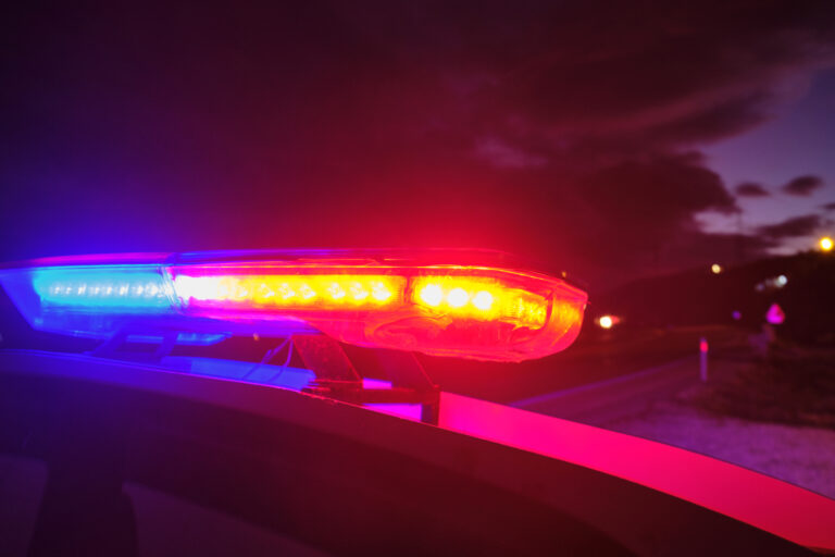 Police car with emergency lights at night.