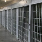 Row of prison cells in a cell block