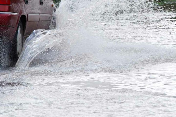 Car driving through flooded street - File Photo by JaneH
