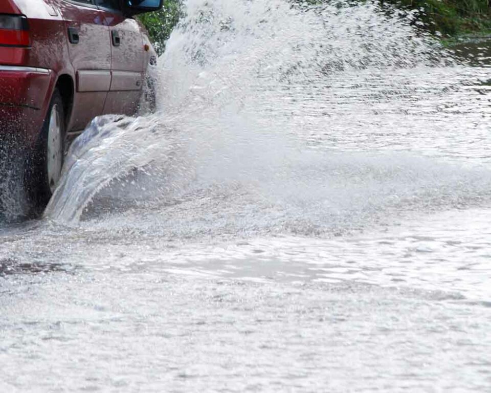 Car driving through flooded street - File Photo by JaneH