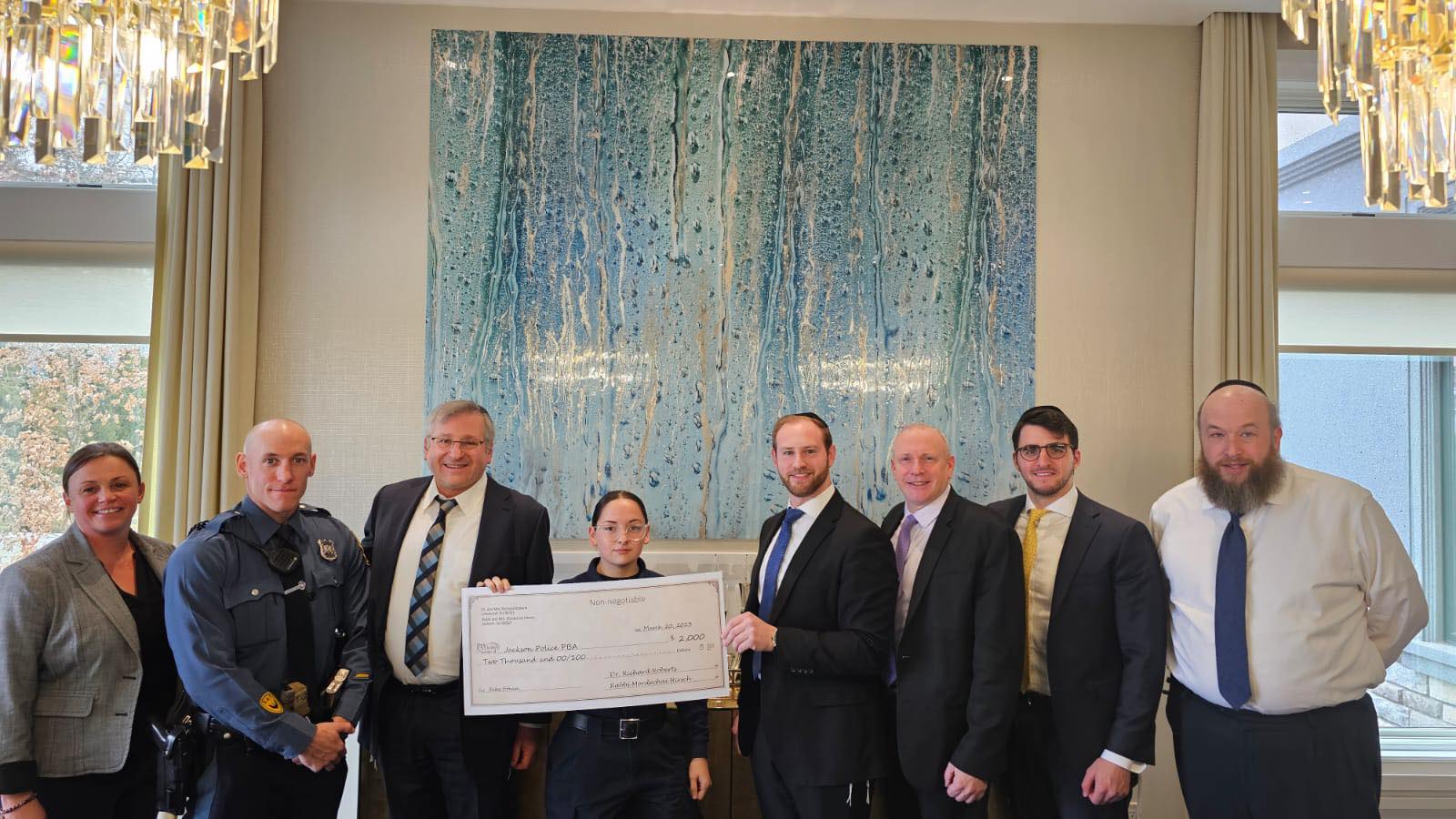 Dr. Roberts, Rabbi Hirsch meet with Jackson police to make generous fundraising donation