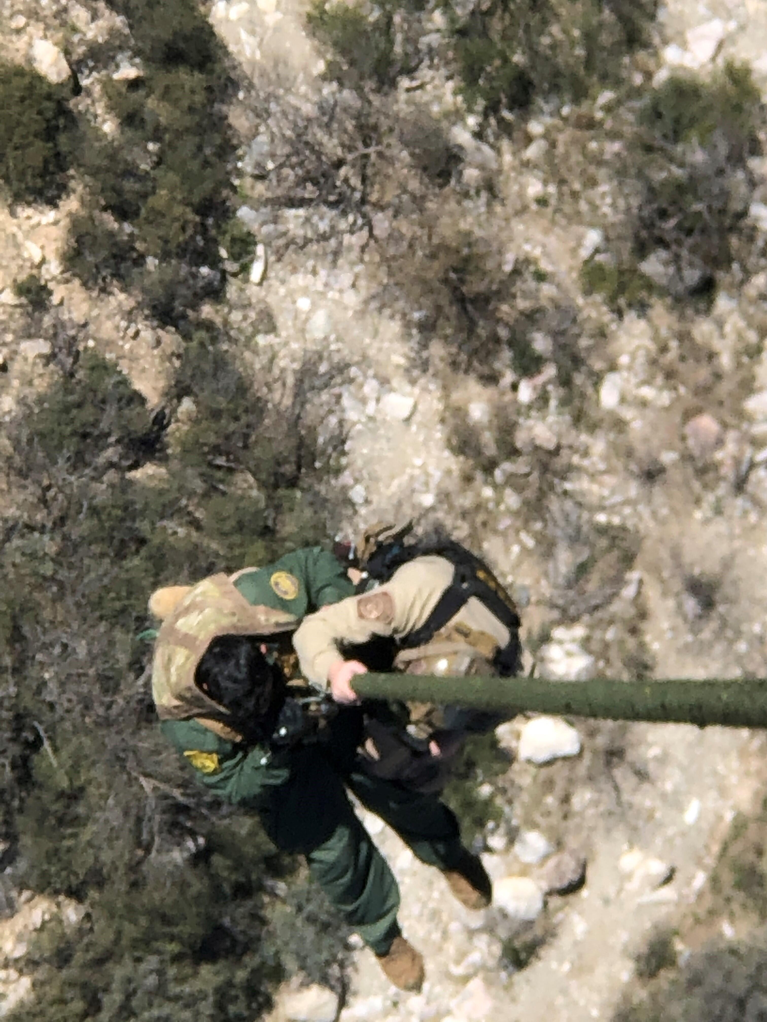 AMO Interdiction Agents hoist an injured Border Patrol agent into a Tucson Air Branch aircraft.