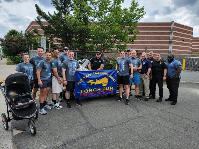 Wakefield police officer carry the torch for special olympics - photo licensed by shore news network.