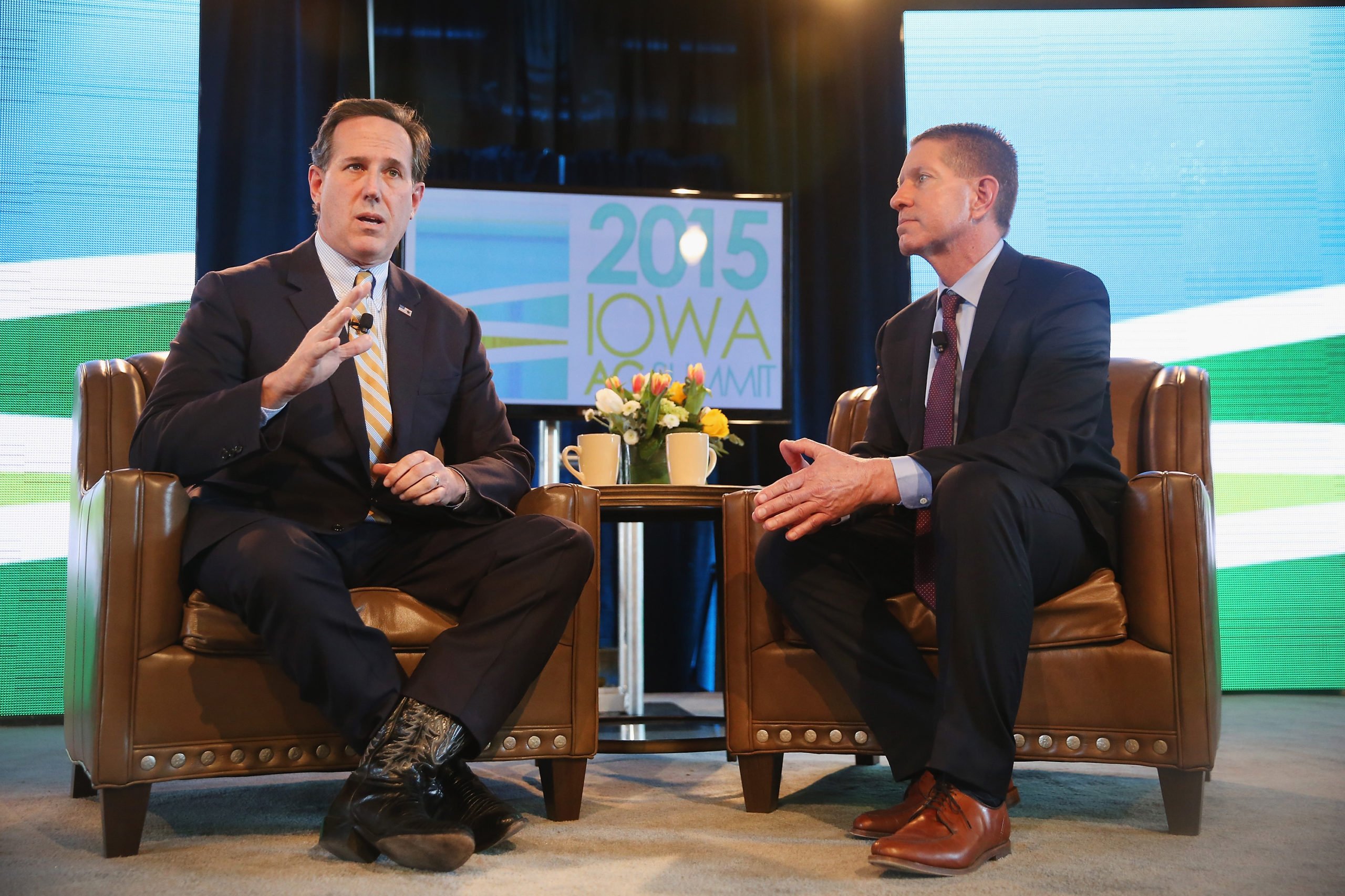 Iowa GOP Reps Lobbied For Green Tax Credits That Benefit A ‘Megadonor’ Supporting Their Campaigns DES MOINES, IA - MARCH 07: Former Pennsylvania Senator Rick Santorum (L) fields questions from Bruce Rastetter at the Iowa Ag Summit on March 7, 2015 in Des Moines, Iowa. The event allowed the invited speakers, many of whom were potential 2016 Republican presidential hopefuls, to outline their views on agricultural issue. (Photo by Scott Olson/Getty Images)