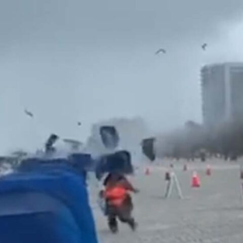 Waterspout runs ashore at florida beach, sending cabanas, umbrellas flying - photo licensed by shore news network.