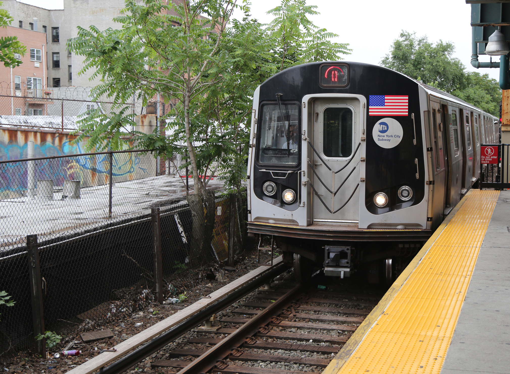 NYC Subway Q Train arriving at Kings Highway Station in Brooklyn