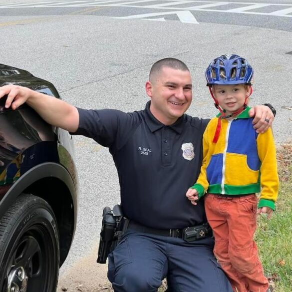 Community caring: officer engages young citizen with police vehicle tour - photo licensed by shore news network.
