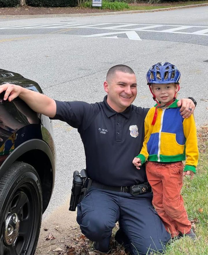 Community Caring: Officer Engages Young Citizen with Police Vehicle Tour