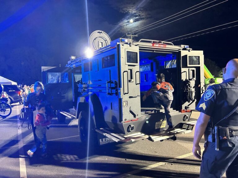 Kids trick or treating out the back of a bear cat