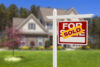 Sold Home For Sale Real Estate Sign in Front of Beautiful New House.
