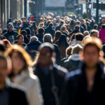 Crowd of people walking on street sidewalk in New York City
