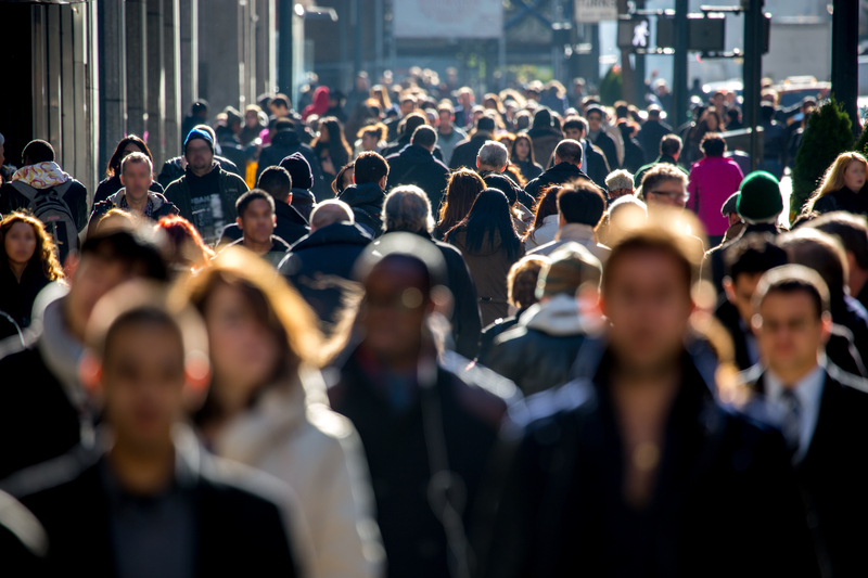 Crowd of people walking on street sidewalk in New York City