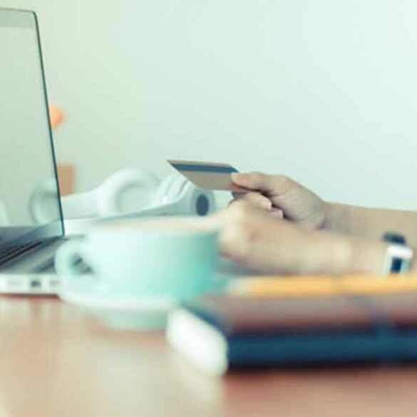 Cyber-monday-sale-tag-banner-with-woman-holding-credit-card-use-laptop-computer-to-shopping-online-at-cafe