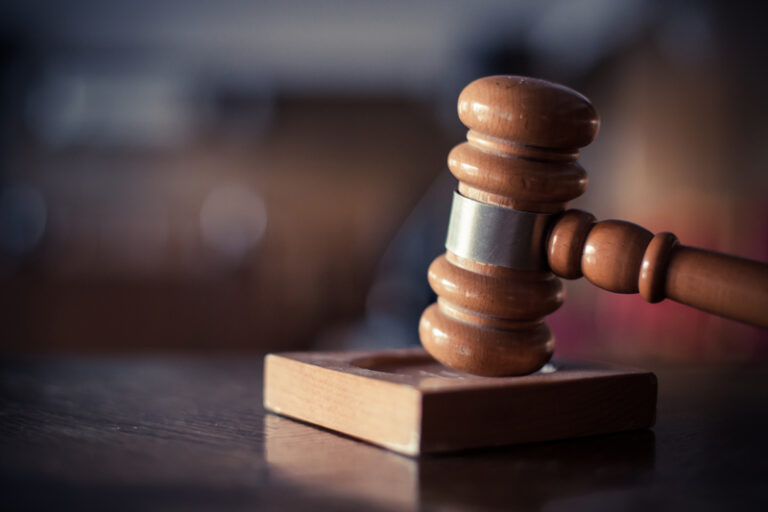 Judge's gavel in a courtroom trial.