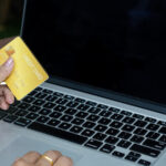 Plastic-credit-card-in-hand-and-use-of-laptop-for-internet-purchase