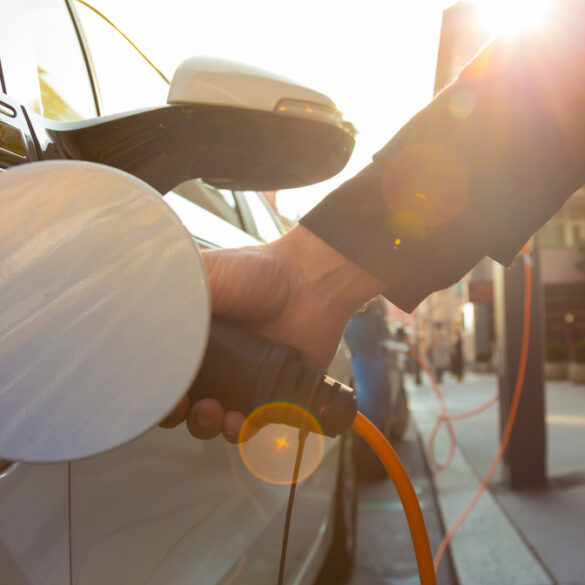 Ower supply for electric car charging. Electric car charging station. Close up of the power supply plugged into an electric car being charged.