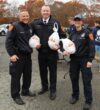 Suffolk police officers help distribute turkeys to families