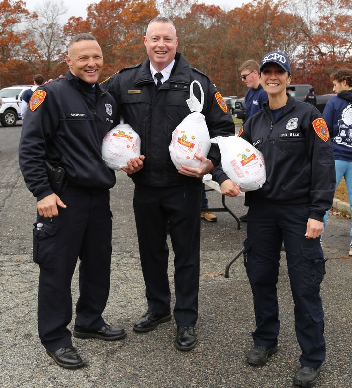 Suffolk Police Officers Help Distribute Turkeys to Families