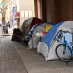 A row of tents on a down town center city Philadelphia street where homeless people are camping in winter.