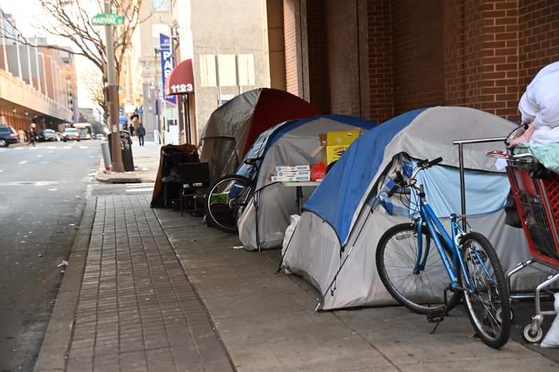 A row of tents on a down town center city Philadelphia street where homeless people are camping in winter.