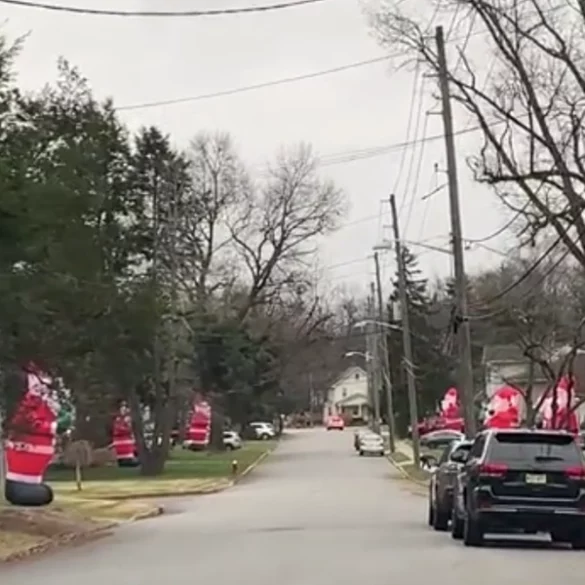 Entire street in north jersey is lined with dozens of huge inflatable santas - photo licensed by shore news network.