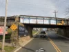 Truck wedged under front street train bridge in red bank