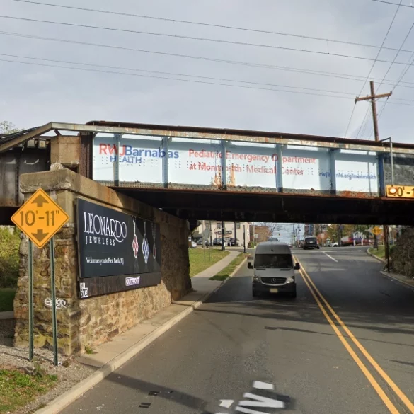 Truck wedged under front street train bridge in red bank - photo licensed by shore news network.