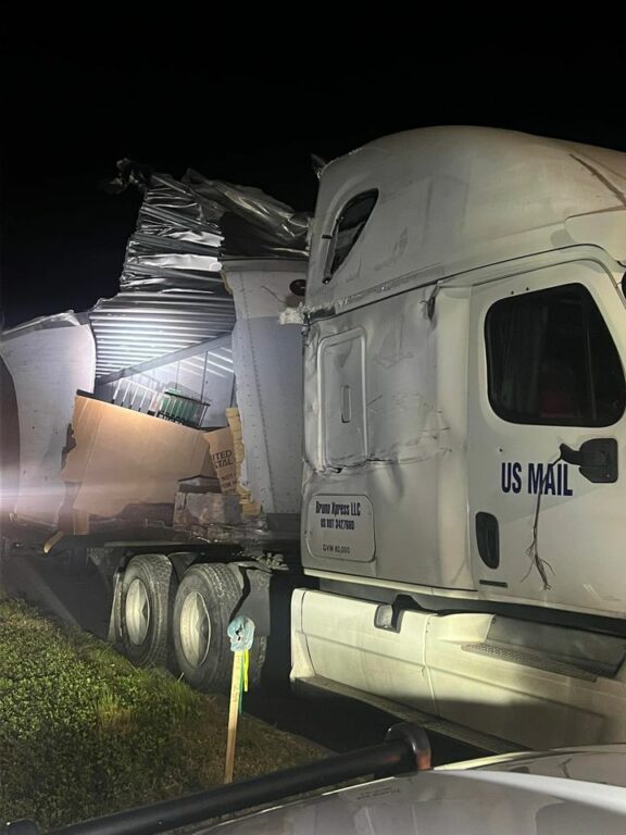 Mail Scattered Across Highway After Postal Carrier Involved in Crash with Semi