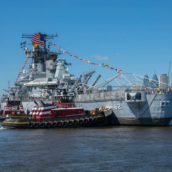 Battleship uss new jersey sets sail down the delaware river for drydocking - photo licensed by shore news network.