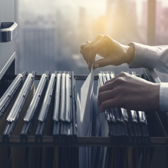 Clerk pulling files from cabinet opra