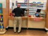 Customer inside a pharmacy shop pick up his prescription at a local Walgreens