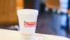 Disposable sugar packet used for coffee sweetner at restaurant fast food with cup of hot coffee