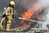 Firefighter-spray-water-on-tractor-trailer-burning
