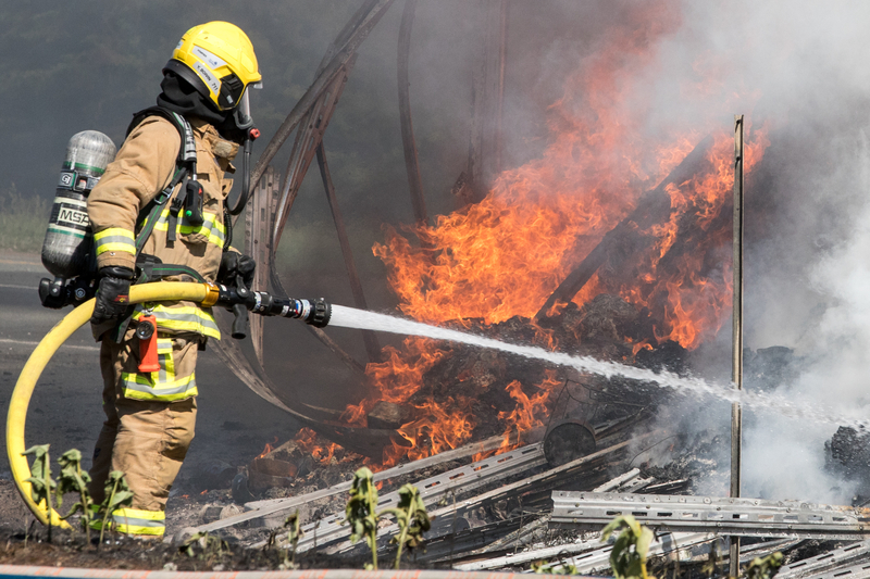 Firefighter-spray-water-on-tractor-trailer-burning