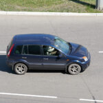 Ford Fusion on city road.