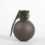 Photo of baseball type grenade on white background
