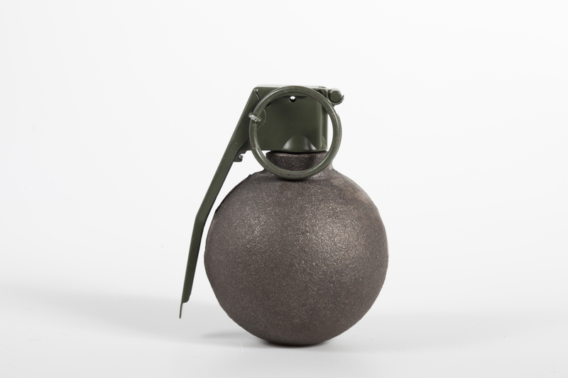 Photo of baseball type grenade on white background