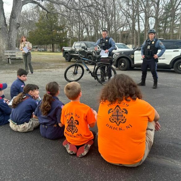 Brick township police officers teach bike safety to local scouts - photo licensed by shore news network.