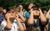Solar eclipse prompts school closures, state of emergency, anticipation of bizarre behavior Looking up at the solar eclipse. A group of children looking up at the 2017 solar eclipse, using protective glasses at the livingston library terrace in livingston,nj.