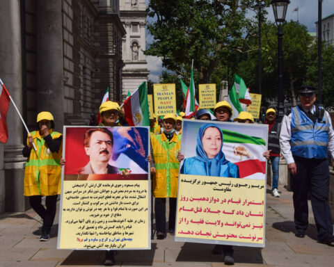 Protest against Iran President Ebrahim Raisi, London, UK 3 August 2021. London, United Kingdom. 3rd Aug 2021. A protester holds a pro-democracy placard with a picture of Maryam Rajavi. Members of the Anglo-Iranian community and supporters of the National Council of Resistance of Iran NCRI gathered outside Downing Street to condemn the regime of president Ebrahim Raisi and to highlight the 1988 massacre of 30,000 political prisoners in Iran.