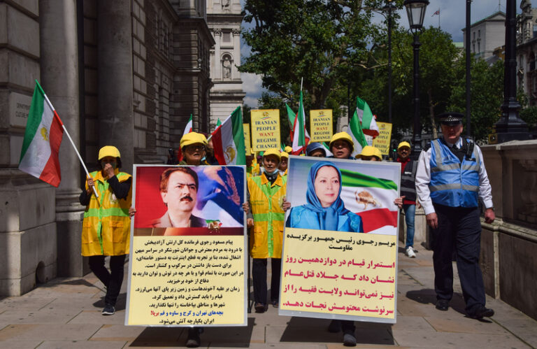 Protest against iran president ebrahim raisi, london, uk 3 august 2021. London, united kingdom. 3rd aug 2021. A protester holds a pro-democracy placard with a picture of maryam rajavi. Members of the anglo-iranian community and supporters of the national council of resistance of iran ncri gathered outside downing street to condemn the regime of president ebrahim raisi and to highlight the 1988 massacre of 30,000 political prisoners in iran.