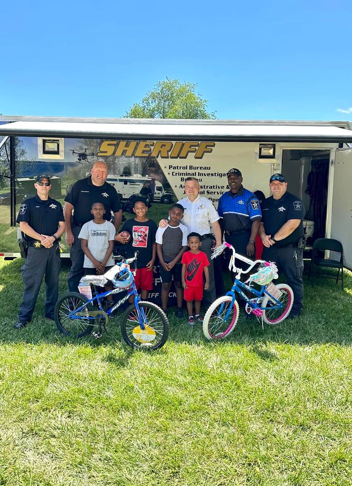 Two Children Walk Away With Bikes At Juneteenth Celebration