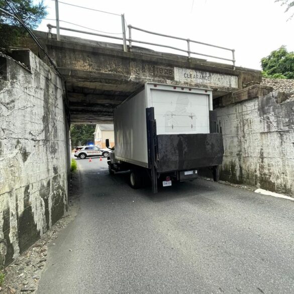 Truck gets stuck under brooke road bridge - photo licensed by shore news network.