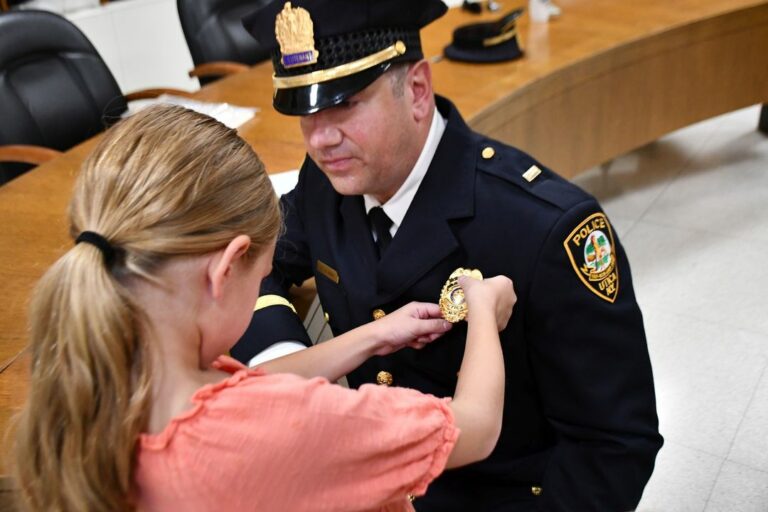 Utica police department promotes three officers at public meeting - photo licensed by shore news network.