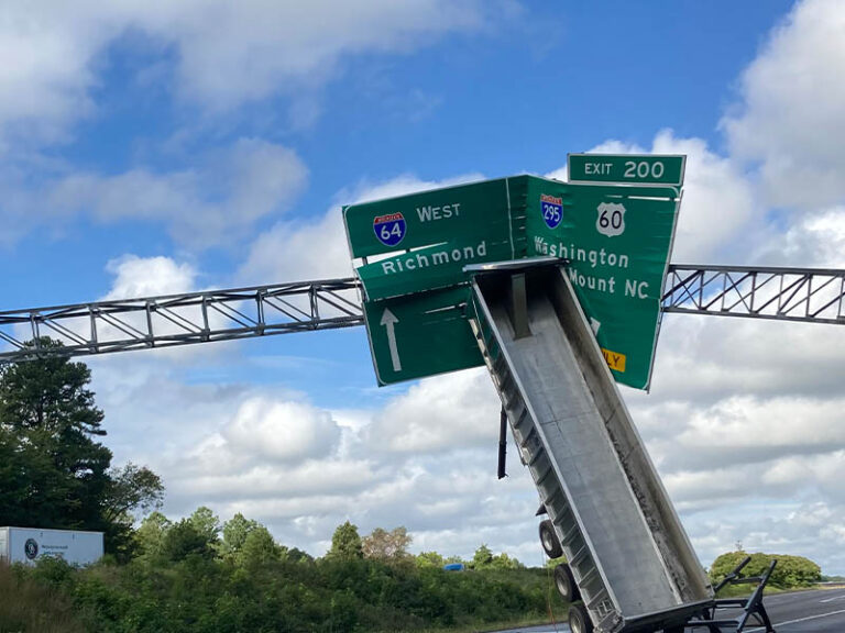 Tractor trailer crashes into highway sign on i-64, driver charged with reckless driving - photo licensed by shore news network.