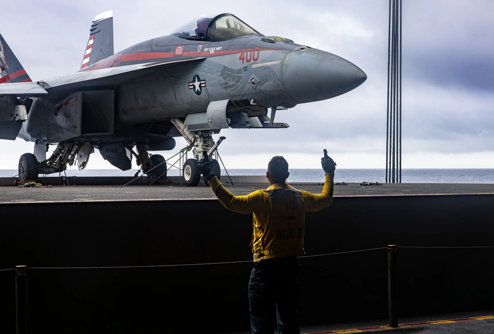 240928-N-DL824-2052 ATLANTIC OCEAN (Sept. 28, 2024) Aviation Boatswain's Mate (Aircraft Handling) 2nd Class Ronmel Quijano, a native of Miami, directs the transport of an F/A-18E Super Hornet, attached to the “Knighthawks” of Strike Fighter Squadron (VFA) 136, from the hangar bay to the flight deck aboard the Nimitz-class aircraft carrier USS Harry S. Truman (CVN 75), Sept. 28. Harry S. Truman, the flagship of the Harry S. Truman Carrier Strike Group