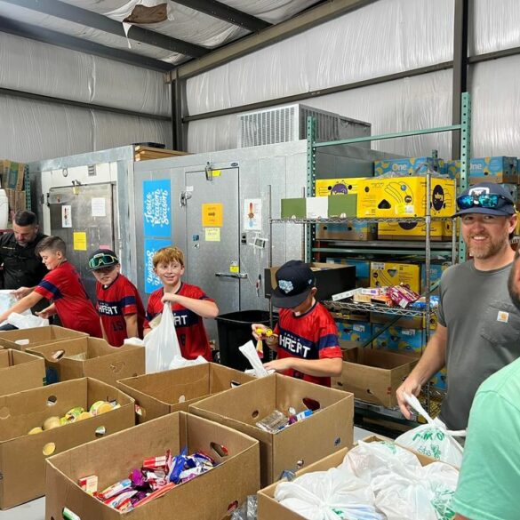 Macon county sheriff and local baseball team assist with food distribution for families in need - photo licensed by shore news network.