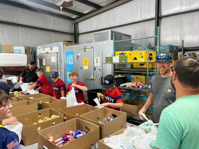 Macon county sheriff and local baseball team assist with food distribution for families in need - photo licensed by shore news network.